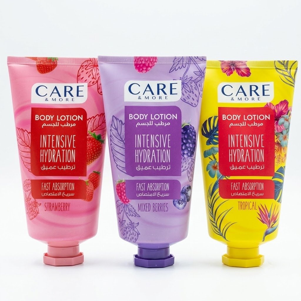 لوشن كير آند مور للترطيب المكثف - متوفر بجميع الروائح المنعشة | Care & More Body Lotion لقطة أمامية واضحة ومنظمة لثلاث عبوات من لوشن مرطب ومغذي الجسم من براند كير آند مور (Care & More) مخصصة للترطيب العميق وسريعة الامتصاص، مرتبة جنباً إلى جنب على خلفية بيضاء سادة. تشمل العبوات من اليسار إلى اليمين: العبوة الوردية برائحة الفراولة (Strawberry)، العبوة البنفسجية برائحة التوت المشكل (Mixed Berries)، والعبوة الصفراء برائحة الفواكه الاستوائية (Tropical)، وتظهر جميعها بتصاميم مبهجة مزينة برطوش ورسومات معبرة عن نوع الرائحة.