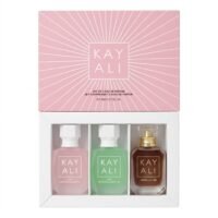 Kay Ali set of 3 Eau de Parfum miniature bottles in a white presentation tray below a pink sunburst box cover, featuring Yum Violet Marshmallow | 01, Yum Pistachio Gelato | 33, and Vanilla | 28.
